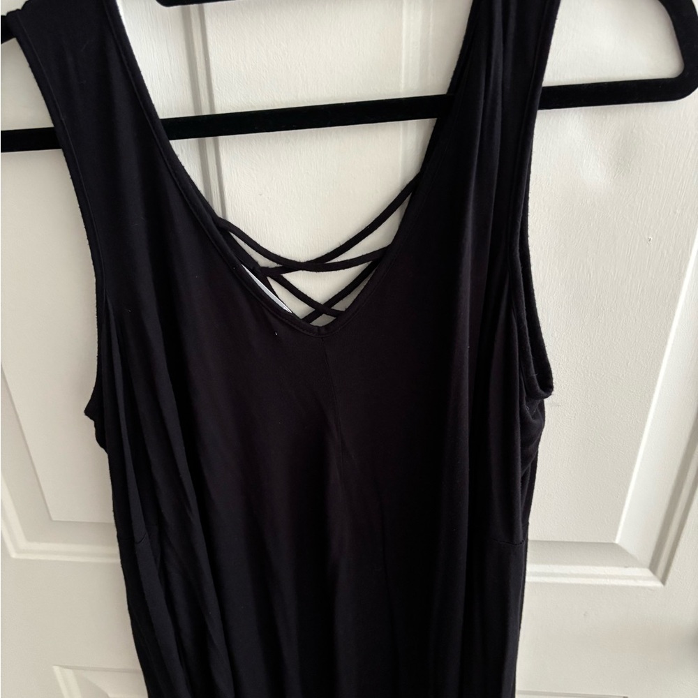 Ella Moss Black cold shoulder top. Criss cross top. Flairs at the bottom